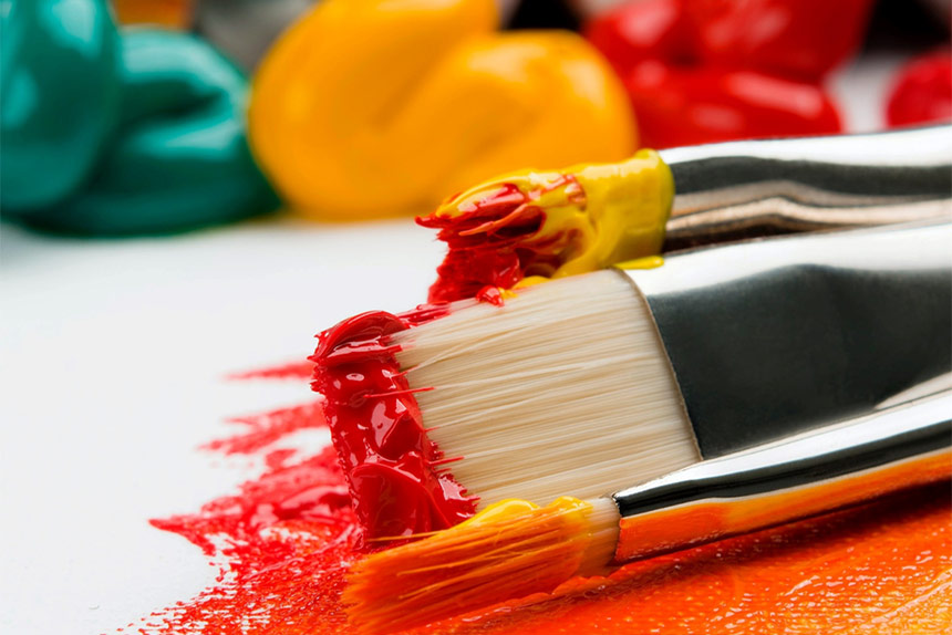 closeup of paintbrushes with paint on them