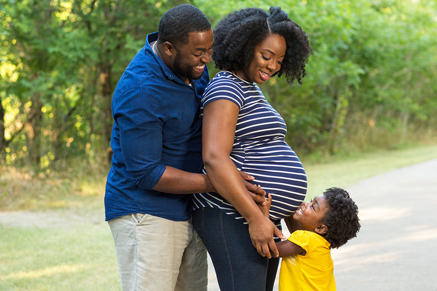 African American man and pregnant woman with their young son