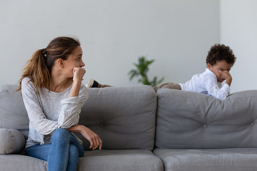 Frustrated mother looking at her crying child