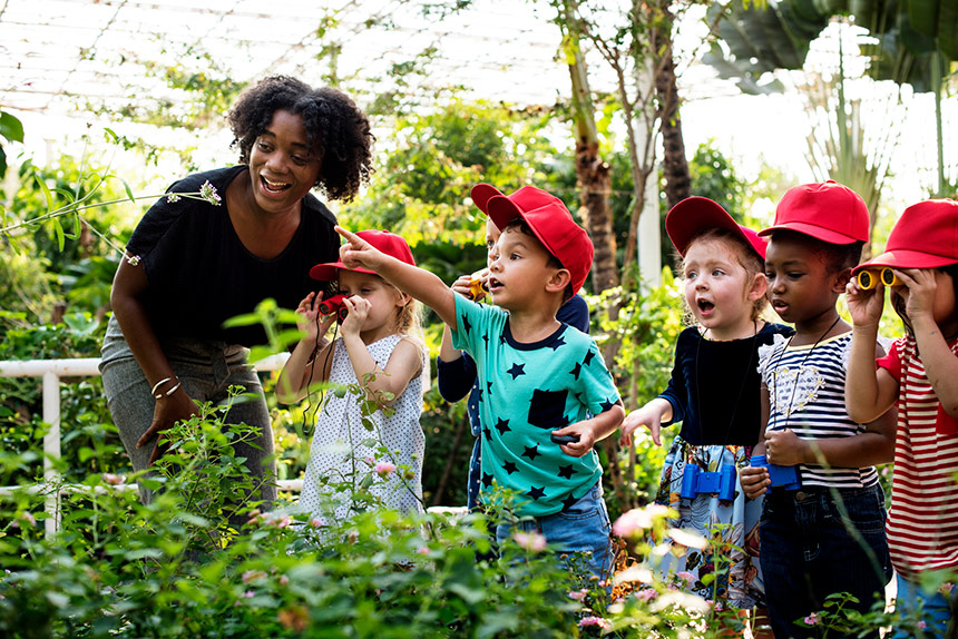 African American woman with group of diverse children at a farm