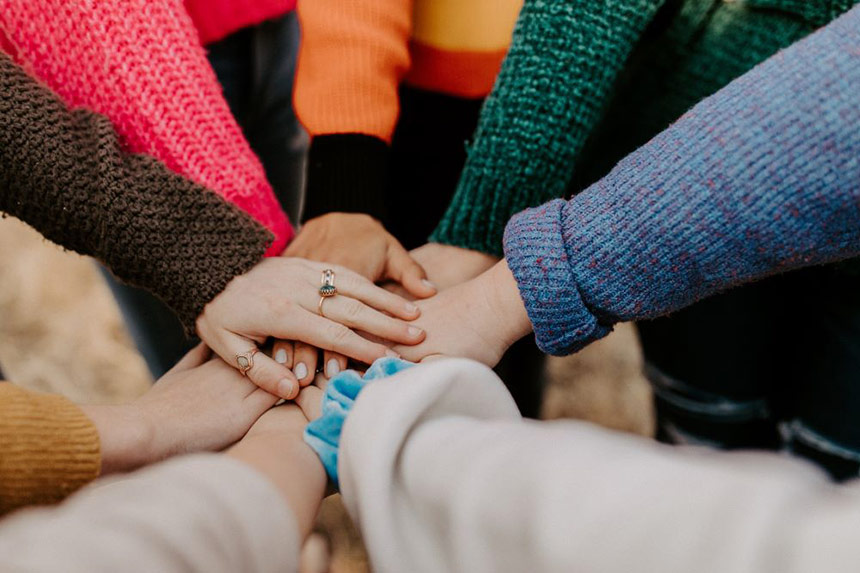 Photo of people with all hands in