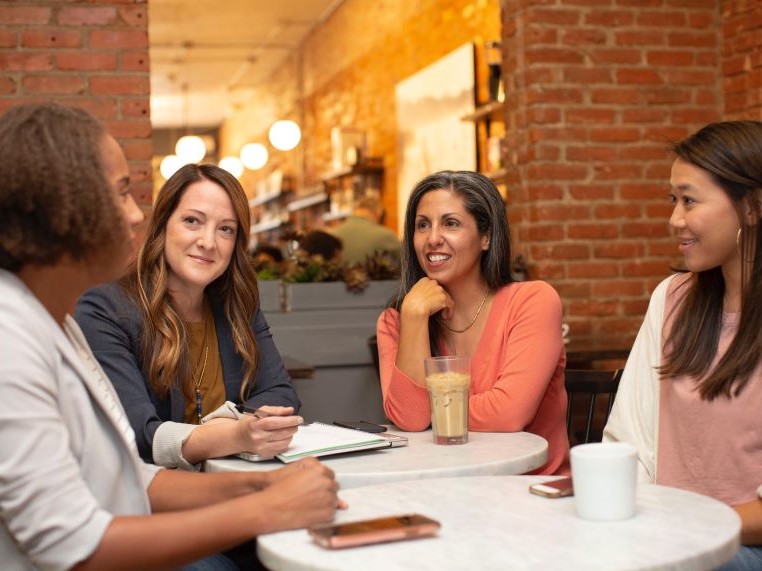 Woman talking around a table