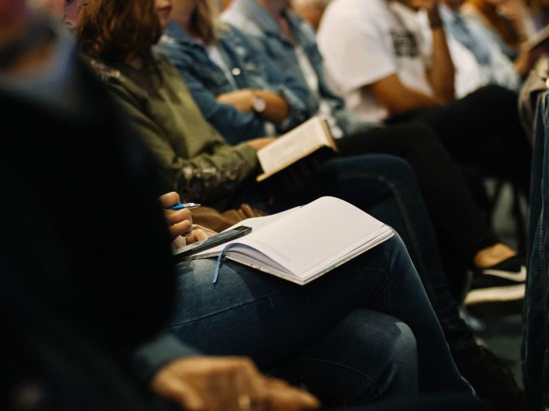 Audience sitting taking notes