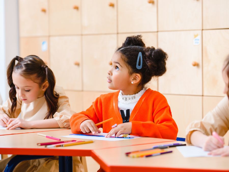 Children at desk in classroom.