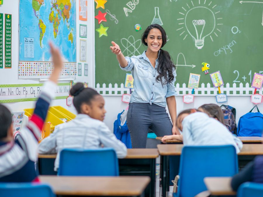 Teacher looking out to classroom of youth for answer.