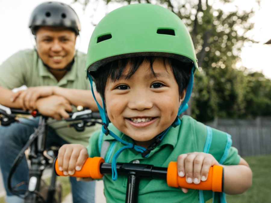 Father and child riding bikes.