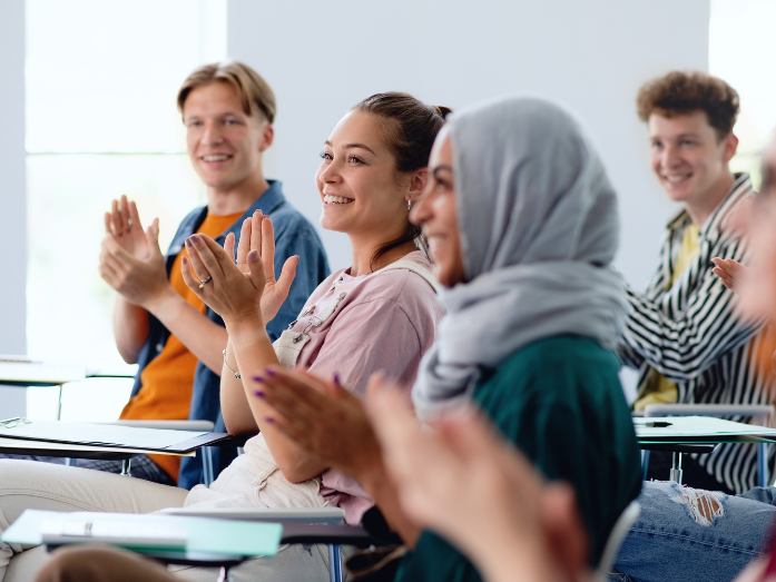 people clapping in classroom