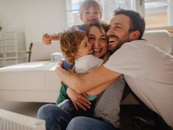 Family of four hugging