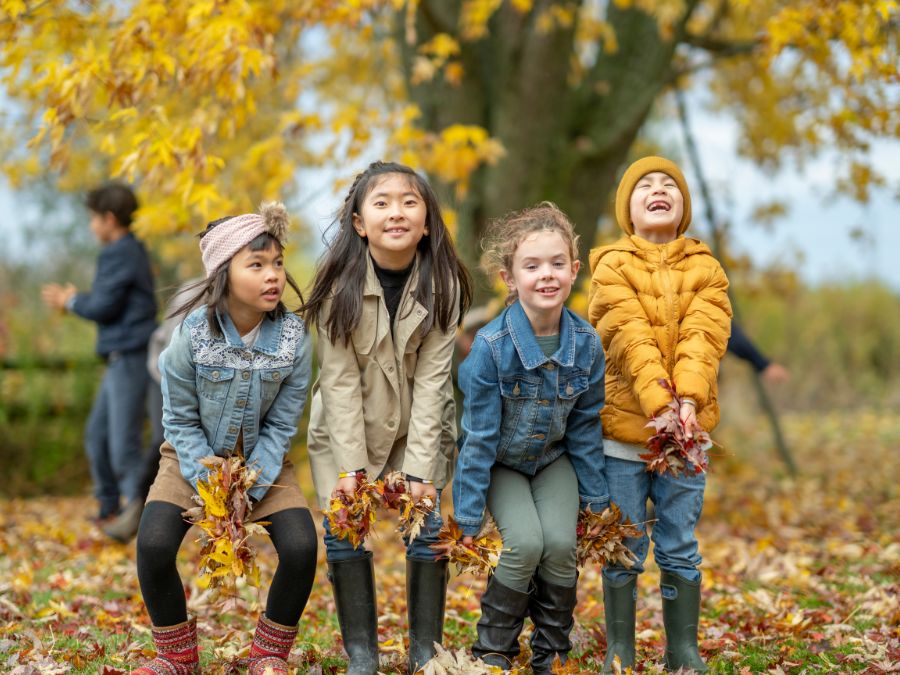 Children throwing leaves.