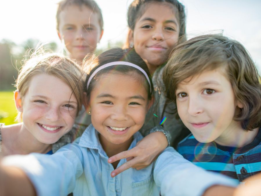 Group of 5 kids taking a selfie.