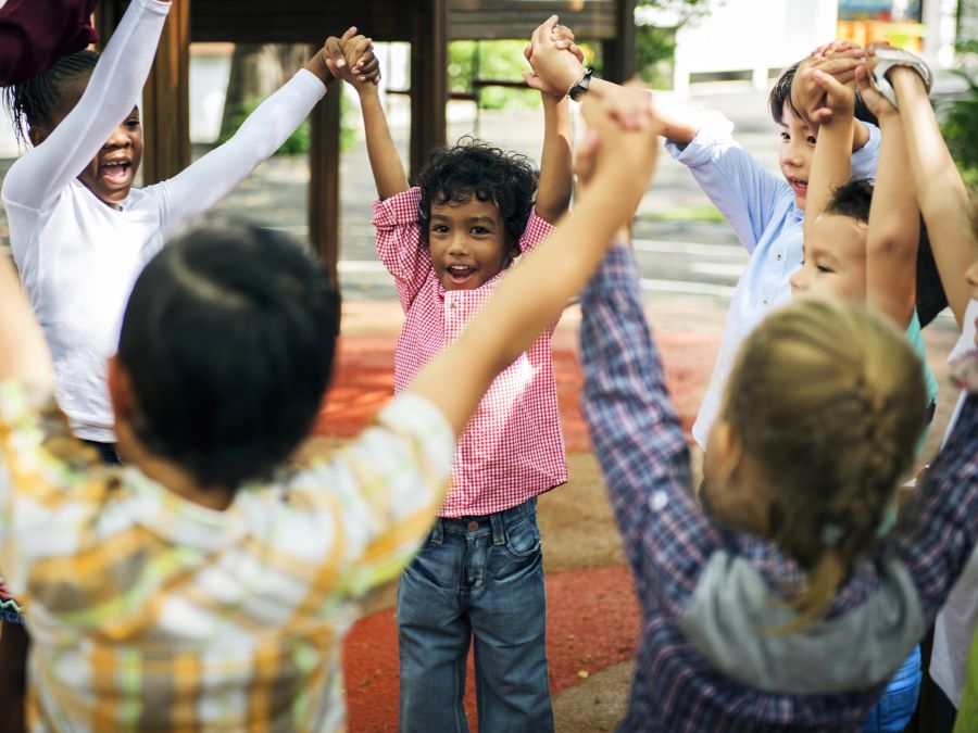 Children holding hands up in the air