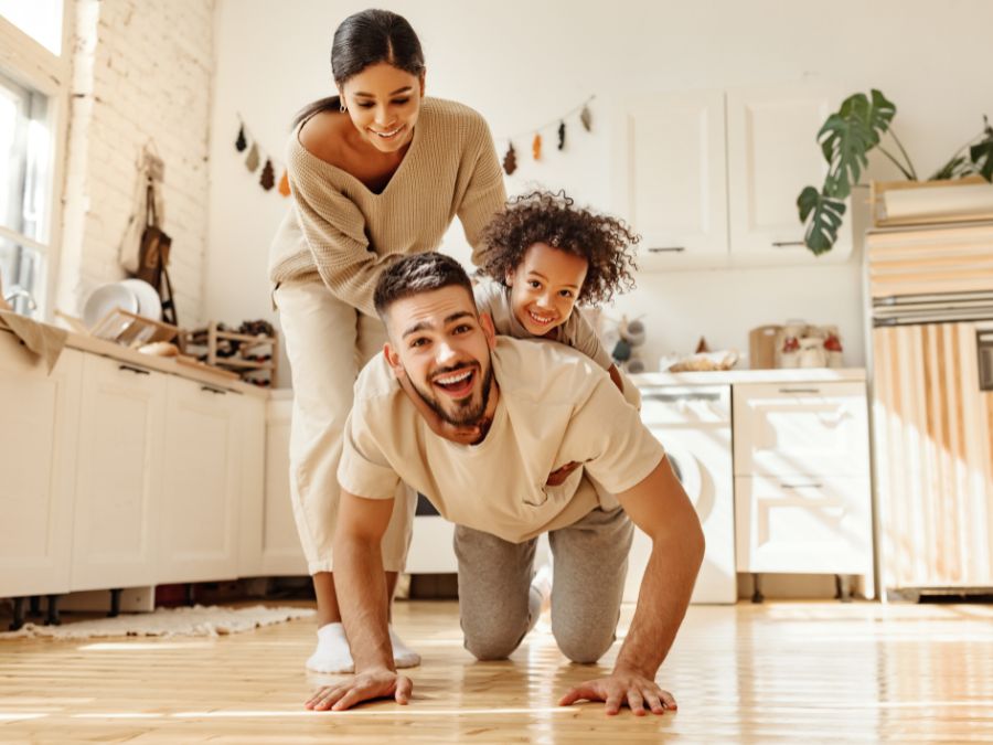 Father with child on his back and mother holding the child