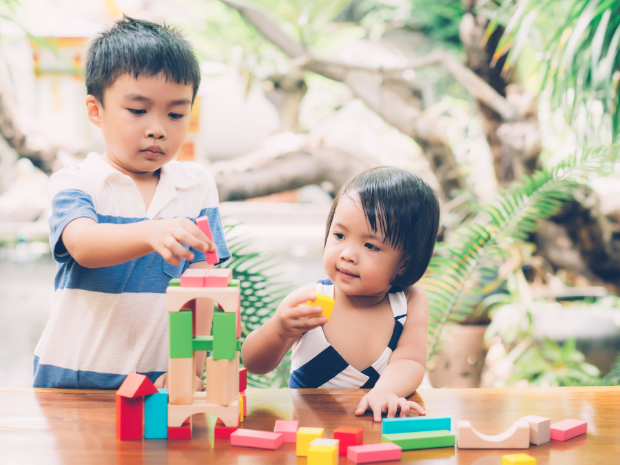 two children playing with blocks